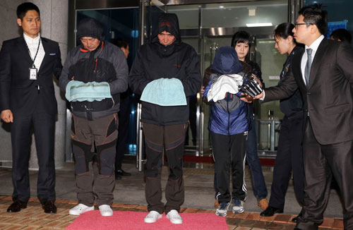 Thuyền trưởng Lee (giữa), thuyền phó Cho (trái) và nữ thuyền phó Park rời tòa án ngày 19.4 - Ảnh: AFP 