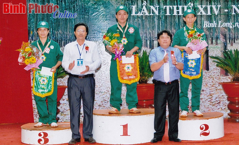 Anh Phạm Văn Huyện (ngoài cùng bên phải) nhận giải nhì hội thi thợ giỏi thu hoạch mủ năm 2014