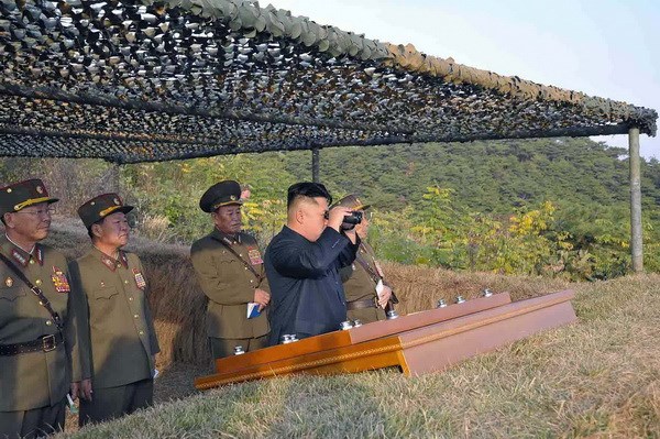 Nhà lãnh đạo Triều Tiên Kim Jong-Un quan sát trận địa qua ống nhòm. (Nguồn: TTXVN/AFP)