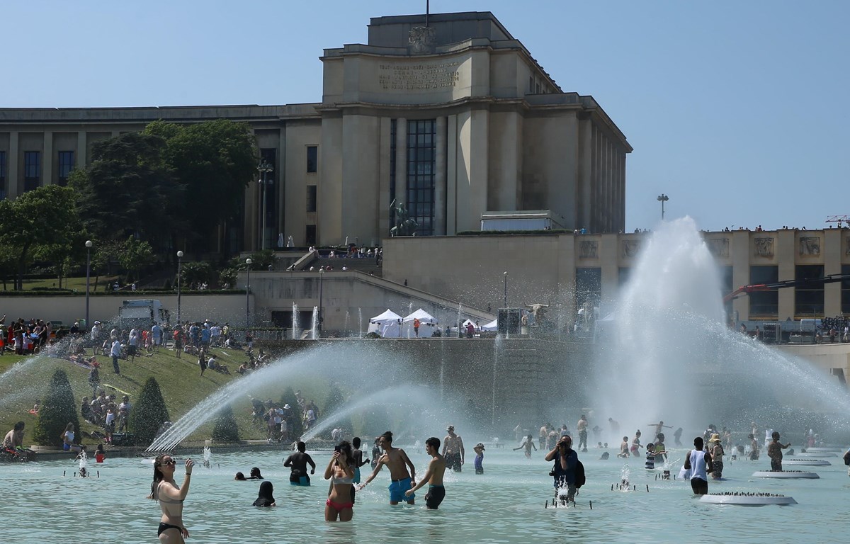 Người dân giải nhiệt tại một đài phun nước ở Paris ảimatildenguyecircnnhacircndẫnđếnnắngnoacutengkỷlụctạ<strong>ketquatructiep bong da</strong>ngày 26/6. (Ảnh: THX/TTXVN)