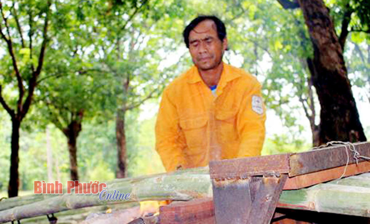 Lửa và khói từ lò than bốc lên, theo phản xạ tự nhiên, anh Y Chon (dân tộc Êđê) phải nheo mắt lại 