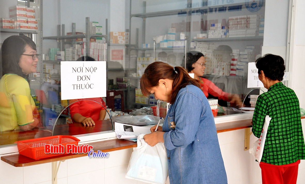 Người dân nhận thuốc tại bộ phận cấp thuốc bảo hiểm y tế ở Trung tâm Y tế huyện Hớn Quản