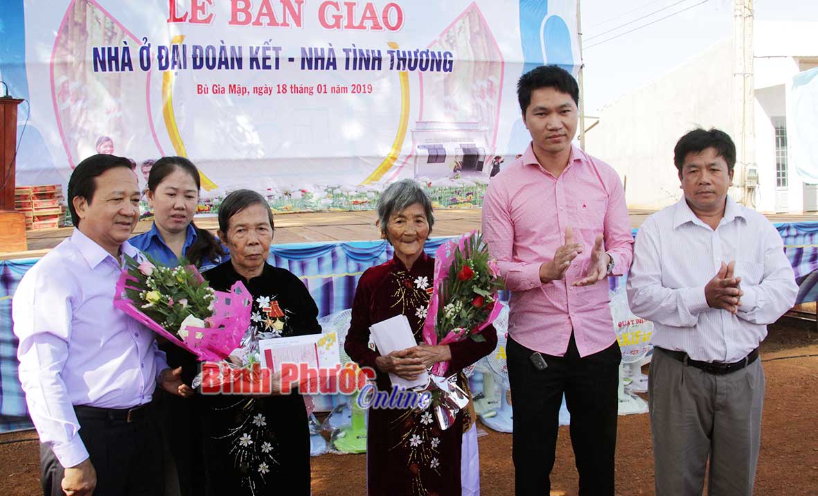 Chủ tịch UBMTTQVN tỉnh Nguyễn Quang Toản (bên trái) trao sổ tiết kiệm cho 2 Mẹ Việt Nam anh hùng ở huyện Bù Gia Mập