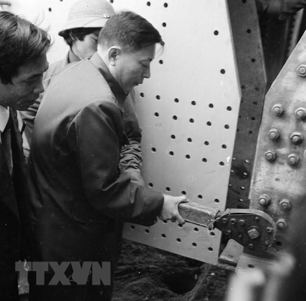  Bộ trưởng Bộ Giao th&ocirc;ng vận tải Đồng Sĩ Nguy&ecirc;n xiết bul&ocirc;ng tượng trưng tại Lễ nối liền dầm cầu Chương Dương (H&agrave; Nội), ng&agrave;y 17/2/1985. Thời gian đ&oacute;, &ocirc;ng l&agrave; người ki&ecirc;n quyết bảo vệ phương &aacute;n phải x&acirc;y dựng cầu Chương Dương khi ch&uacute;ng ta định chỉ l&agrave;m duy nhất cầu Thăng Long bắc qua s&ocirc;ng Hồng tại địa b&agrave;n Thủ đ&ocirc;. (Ảnh: Bảo Hanh/TTXVN)