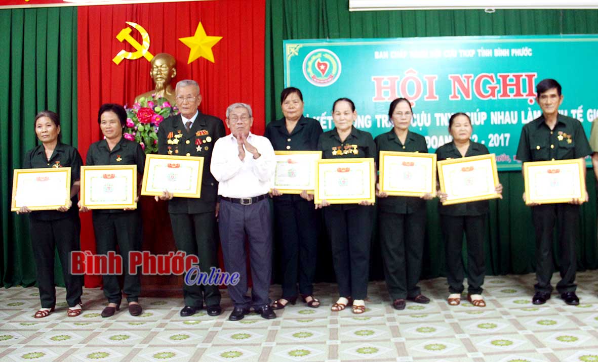Chủ tịch Hội Cựu TNXP tỉnh Trần Văn Vang tặng giấy khen cho những tập thể, cá nhân có thành tích trong phong trào giúp nhau làm kinh tế giỏi