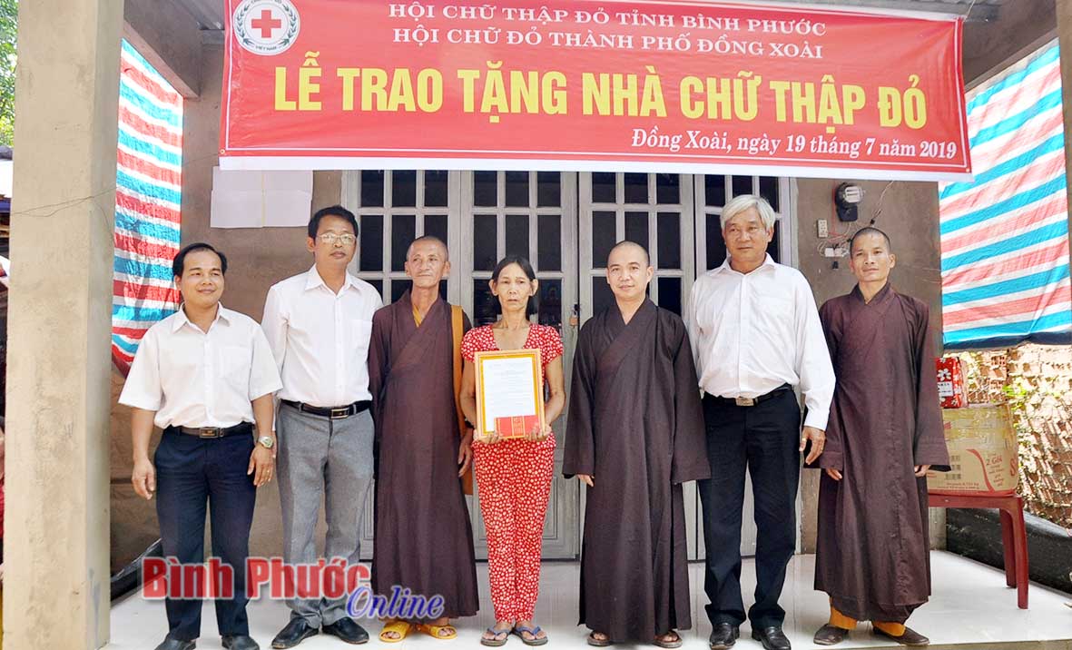 Lãnh đạo Hội Chữ thập đỏ tỉnh và trụ trì chùa Thanh Lâm trao quyết định tặng nhà cho gia đình chị Nguyễn Thị Vui