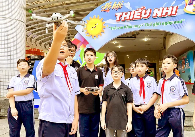 Các em học sinh được hướng dẫn lắp ráp và điểu khiển drone tại CLB drone ở Nhà Thiếu nhi TPHCM. Ảnh: DŨNG PHƯƠNG CN1c.jpg