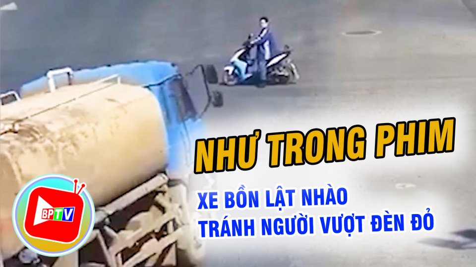 Tránh người vượt đèn đỏ, xe bồn lật nhào như phim hành động